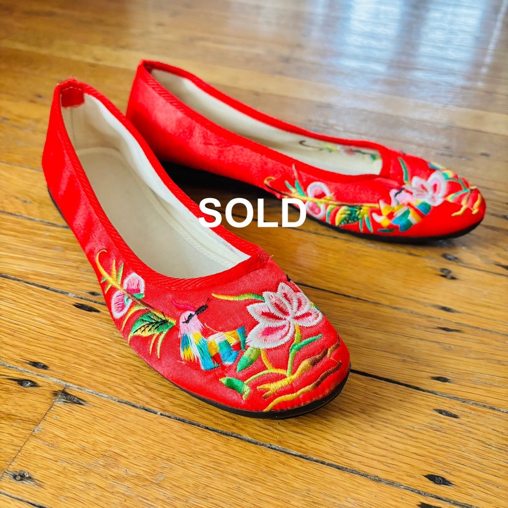 Red embroidered satiny flats with a touch of whimsy, fabric upper, rubber sole.